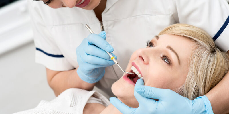 Woman getting a dental cleaning in Independence, KY